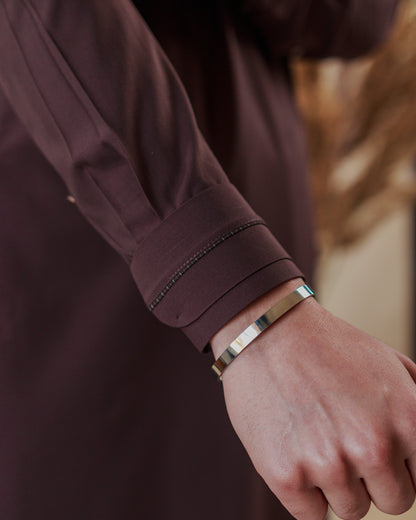 Close-up of brown kameez cuff