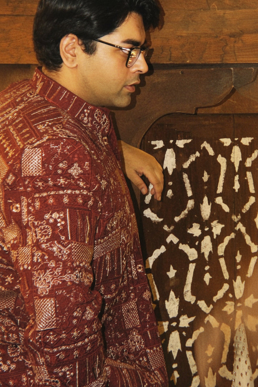 Two people in formal attire standing close to each other indoors.