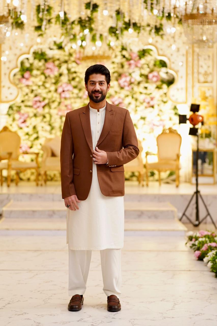 brown blazer and white traditional outfit 
